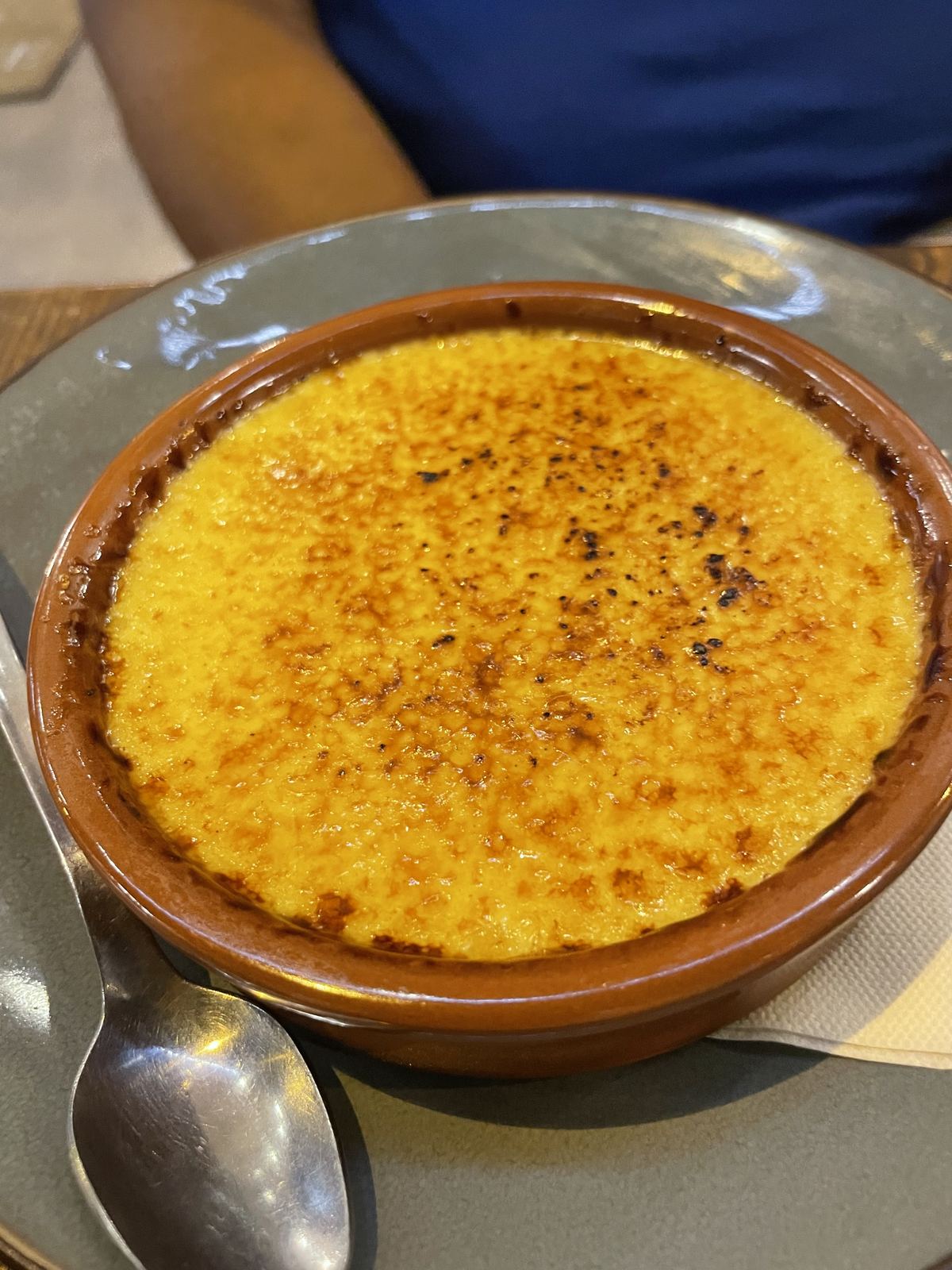 Crème brûlée — perfect caramelised golden top in a terracotta bowl